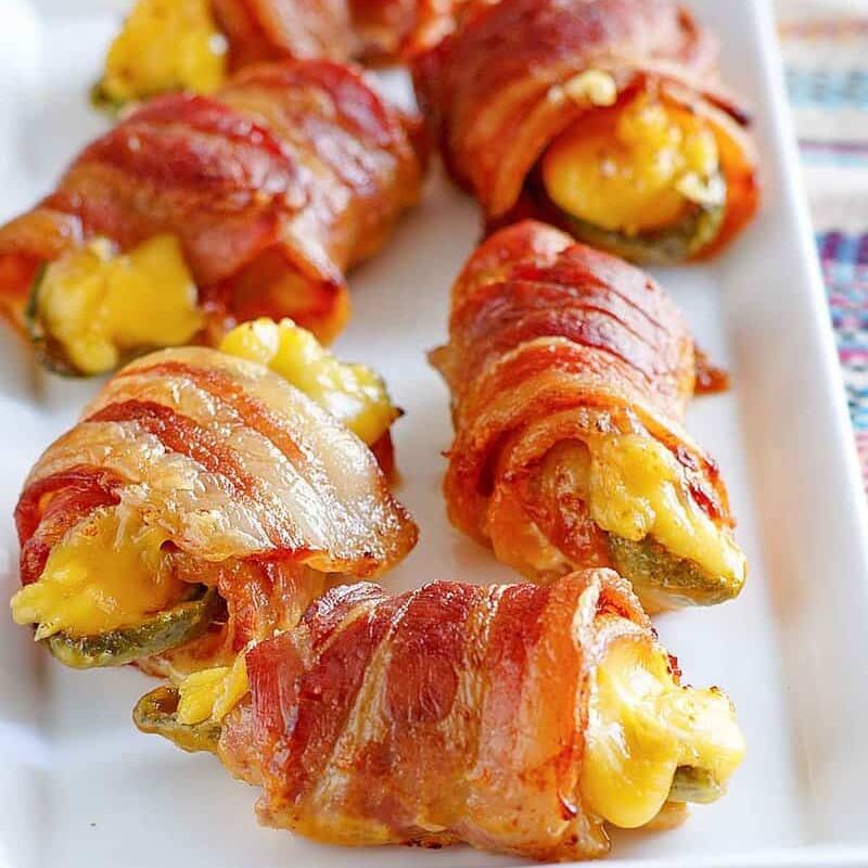 Wrapped jalapeños filled with melted cheese, perfect for air fryer recipes.