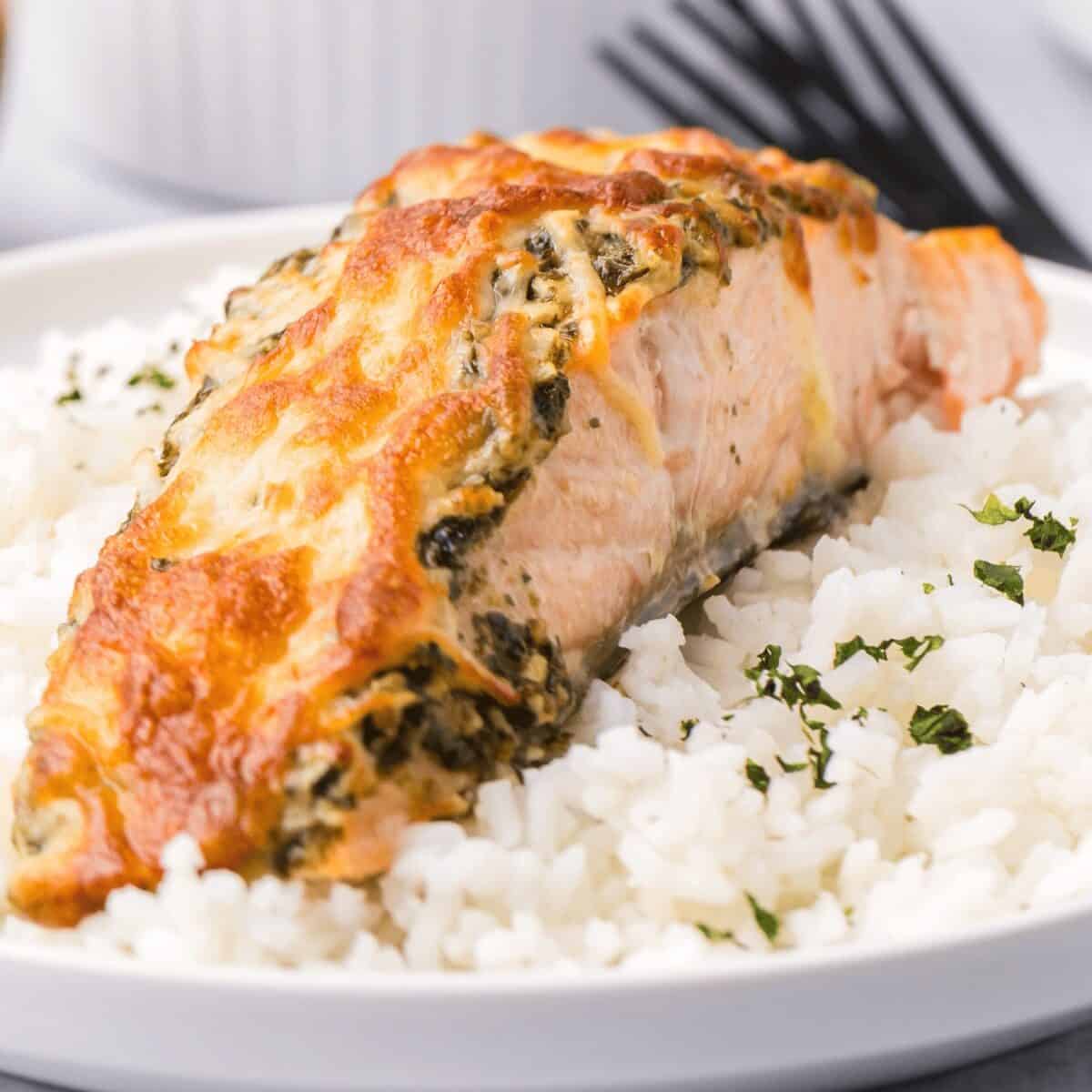 Delicious baked salmon topped with spinach and cheese, cooked in an air fryer.